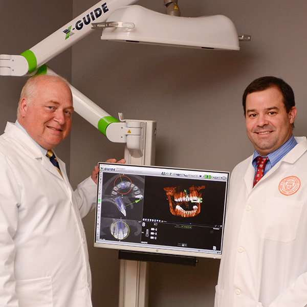 Photo of Dr Parrish and Dr Vierra next to dental scanner