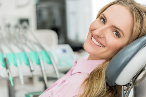 patient smiling at the dental chair at United Smile Centres, Louisville, KY