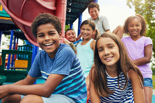 Image of kids smiling at playground near United Smile Centres.