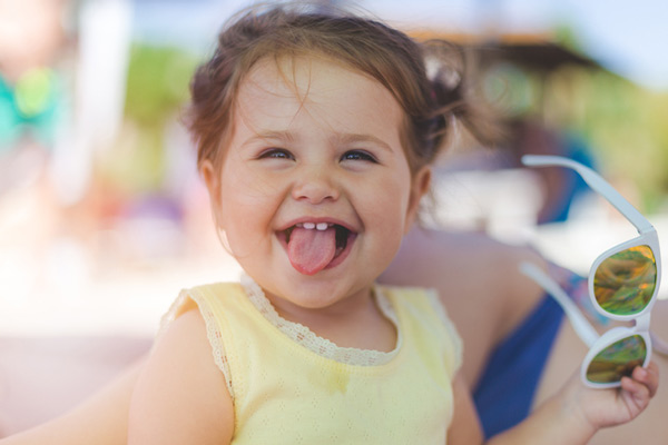 Child smiling and sticking out tongue.