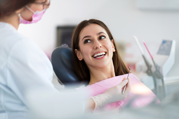 Image of a smiling woman looking at the dental professional, at United Smile Centres.